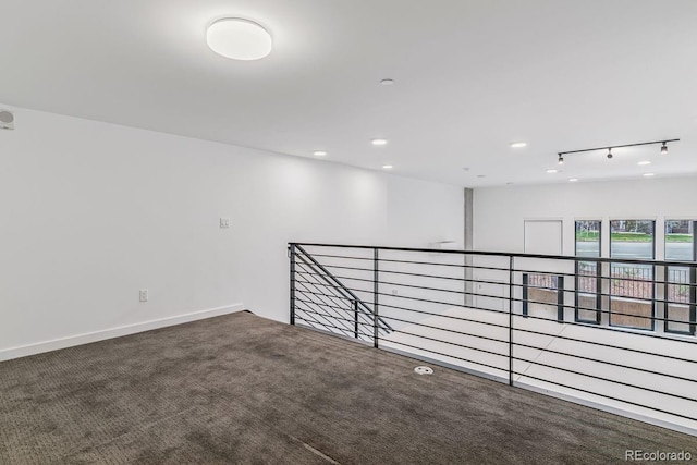 carpeted spare room with track lighting, baseboards, and recessed lighting