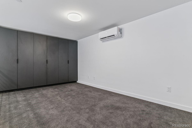 unfurnished bedroom featuring baseboards, carpet floors, and a wall mounted AC