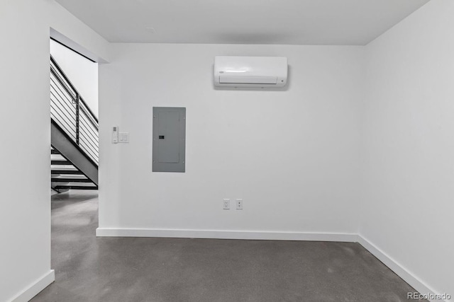 empty room featuring finished concrete floors, electric panel, stairway, baseboards, and an AC wall unit