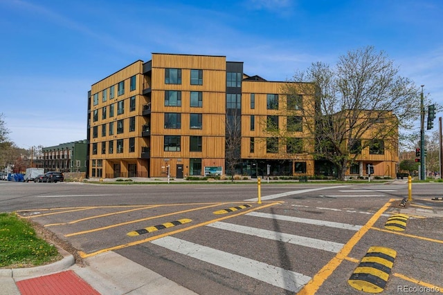 view of building exterior featuring uncovered parking