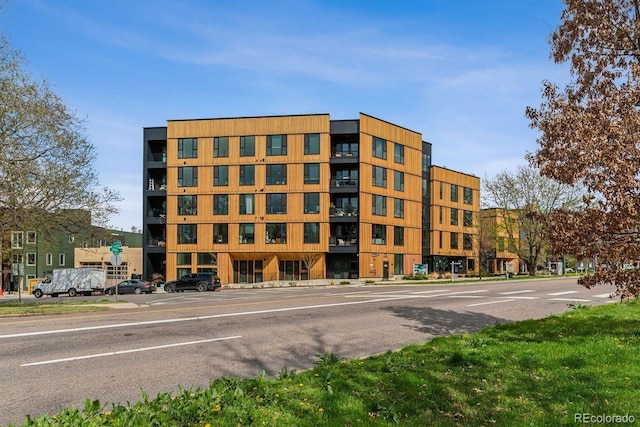 view of building exterior featuring uncovered parking