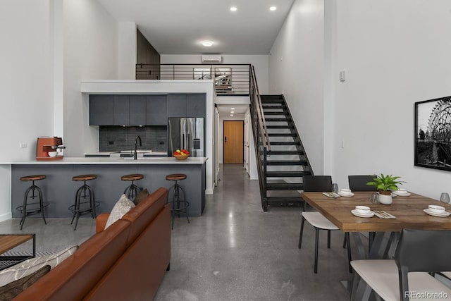 interior space featuring stairs, recessed lighting, and concrete floors