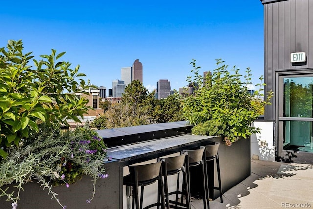 balcony featuring a view of city and outdoor wet bar