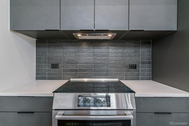 kitchen with light countertops, modern cabinets, electric stove, gray cabinetry, and tasteful backsplash