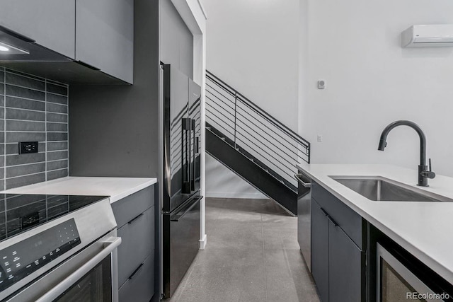 kitchen with a sink, stainless steel appliances, light countertops, tasteful backsplash, and a wall mounted AC