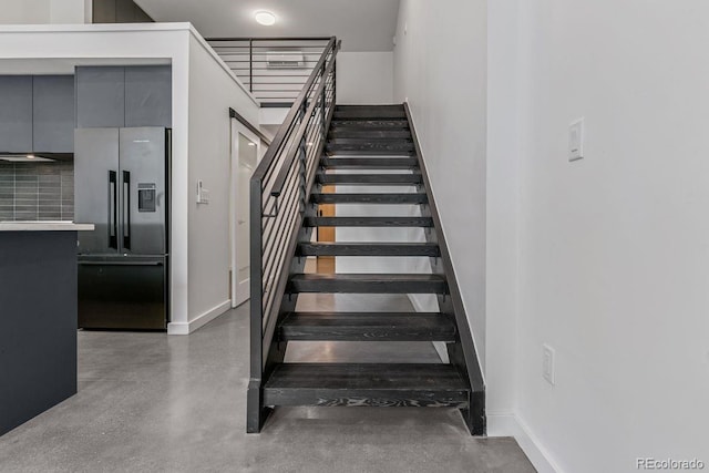 stairway featuring baseboards