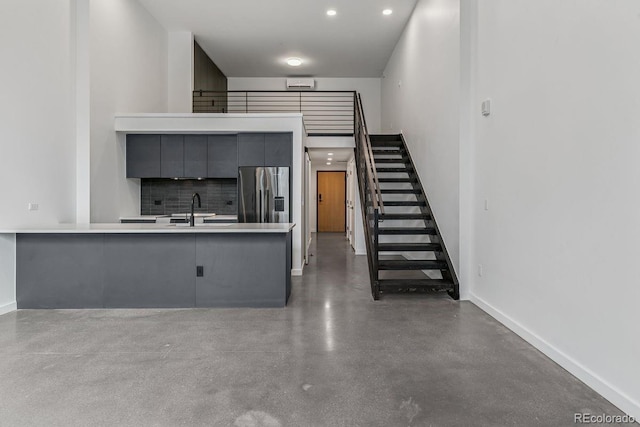 interior space with concrete flooring, baseboards, and recessed lighting