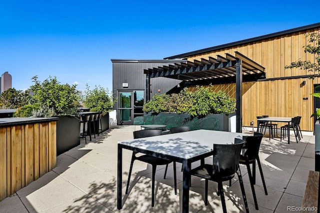 view of patio with a pergola, outdoor dry bar, and outdoor dining space
