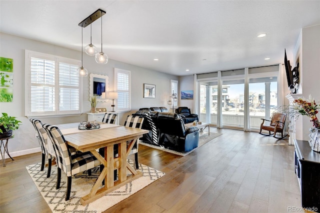 dining area with hardwood / wood-style floors and a textured ceiling