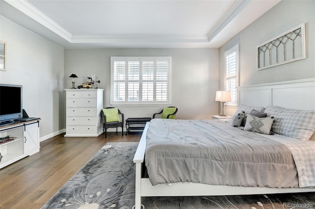 bedroom with ornamental molding, multiple windows, a raised ceiling, and dark wood-type flooring