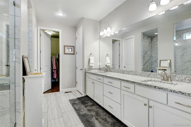 bathroom featuring hardwood / wood-style floors, an enclosed shower, and vanity