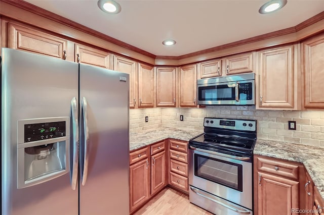 kitchen with appliances with stainless steel finishes, light stone countertops, backsplash, ornamental molding, and recessed lighting