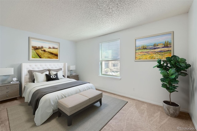 bedroom featuring carpet flooring, a textured ceiling, and baseboards