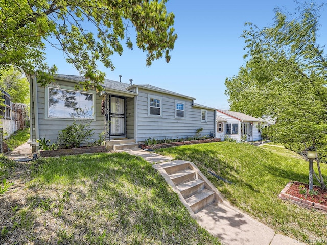 835 Knox Ct, Denver, CO 80204 - ranch-style house with a front lawn and fence