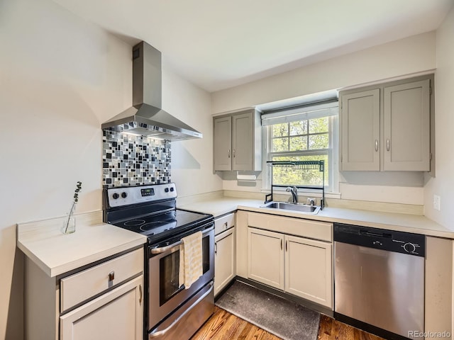 835 Knox Ct, Denver, CO 80204 - kitchen featuring light countertops, ventilation hood, appliances with stainless steel finishes, and a sink