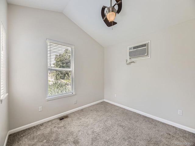 835 Knox Ct, Denver, CO 80204 - carpeted empty room featuring a ceiling fan, an AC wall unit, baseboards, visible vents, and vaulted ceiling