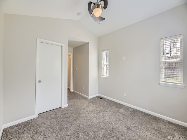 835 Knox Ct, Denver, CO 80204 - unfurnished bedroom featuring carpet, vaulted ceiling, and multiple windows