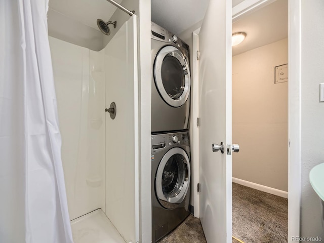 835 Knox Ct, Denver, CO 80204 - laundry room featuring baseboards, stacked washer / drying machine, and carpet floors