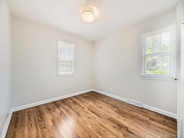 835 Knox Ct, Denver, CO 80204 - spare room with visible vents, wood finished floors, and baseboards