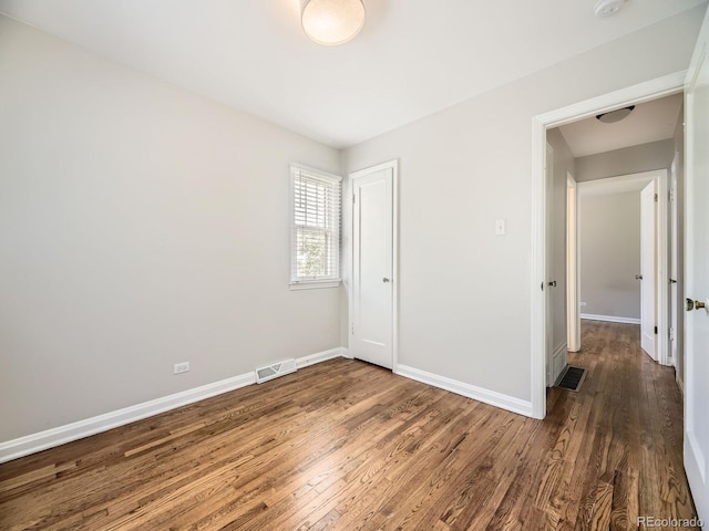 835 Knox Ct, Denver, CO 80204 - unfurnished bedroom featuring visible vents, wood finished floors, and baseboards