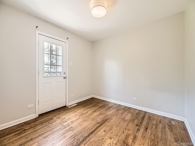 835 Knox Ct, Denver, CO 80204 - unfurnished room featuring baseboards, visible vents, and wood finished floors