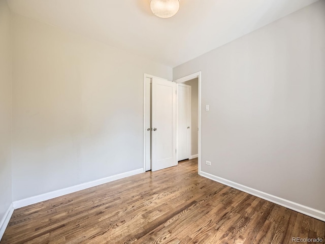 835 Knox Ct, Denver, CO 80204 - empty room with wood finished floors and baseboards