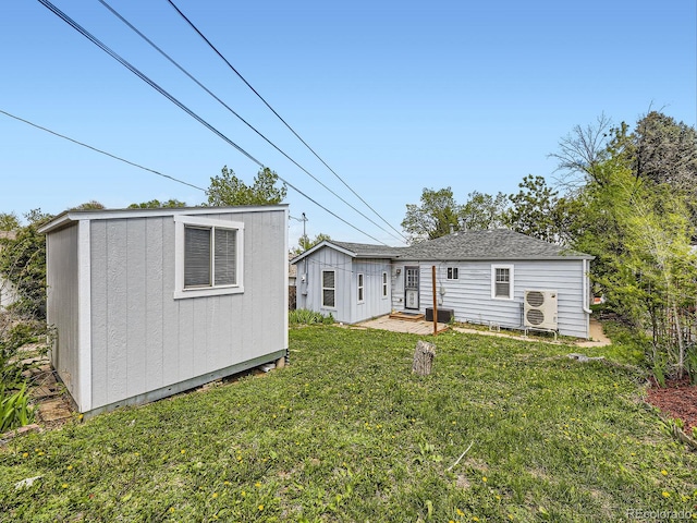 835 Knox Ct, Denver, CO 80204 - back of property with a yard, an outbuilding, a shed, ac unit, and a patio area