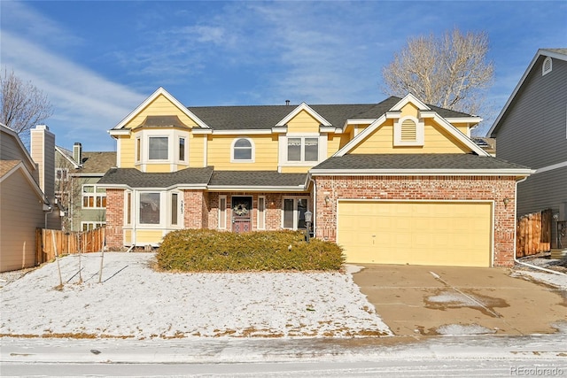 view of front of house with a garage, fence, concrete driveway, and brick siding