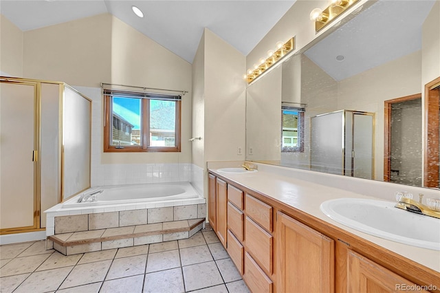 full bathroom with lofted ceiling, a garden tub, a sink, and tile patterned floors