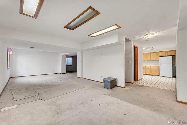 spare room with concrete floors and baseboards