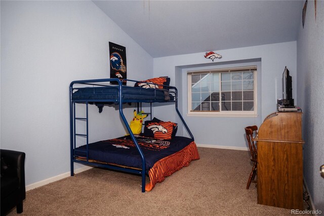 carpeted bedroom with lofted ceiling