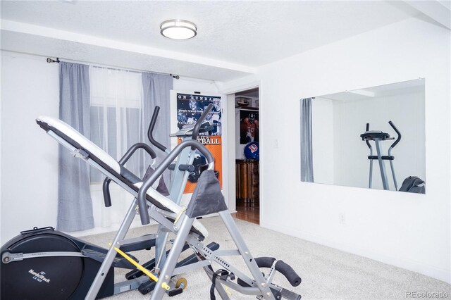 exercise room with a textured ceiling