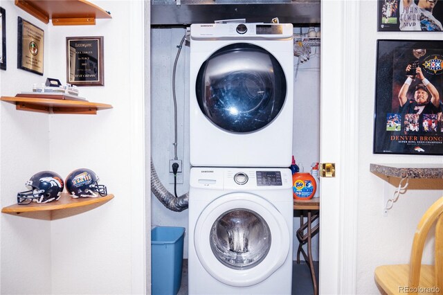 washroom with stacked washer and dryer