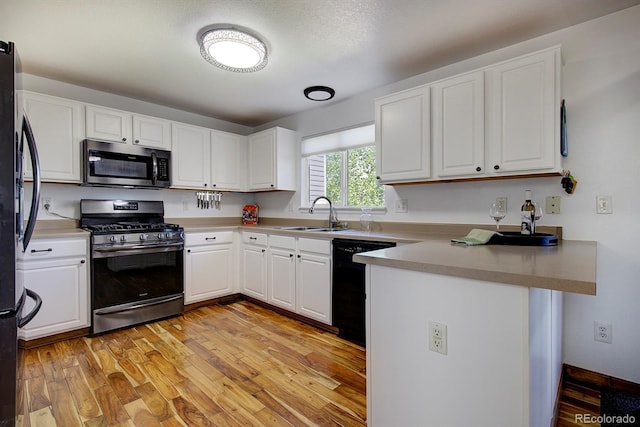 22739 E Prentice Pl, Aurora, CO 80015 - kitchen featuring black appliances, a sink, a peninsula, and white cabinets