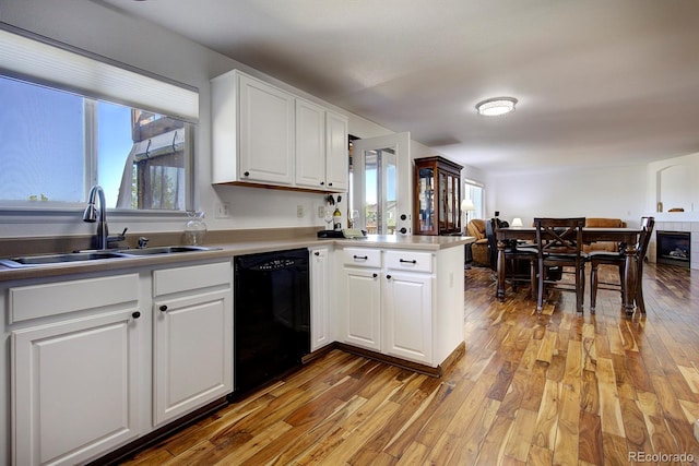 22739 E Prentice Pl, Aurora, CO 80015 - kitchen featuring dishwasher, a sink, a peninsula, and plenty of natural light