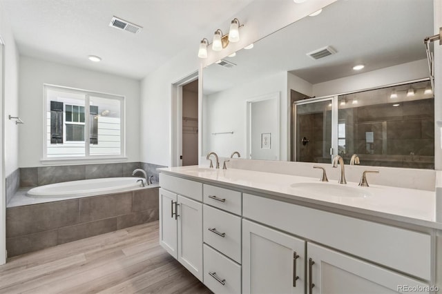 bathroom featuring a shower stall, visible vents, and a sink