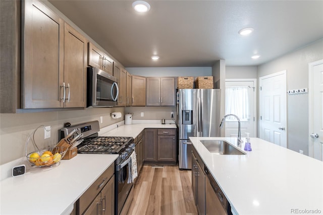 12743 Ulster St, Thornton, CO 80602 - kitchen featuring stainless steel appliances, recessed lighting, light countertops, and light wood-style floors