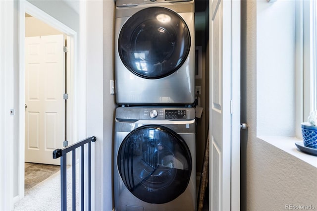 12743 Ulster St, Thornton, CO 80602 - laundry room featuring stacked washing machine and dryer and carpet flooring