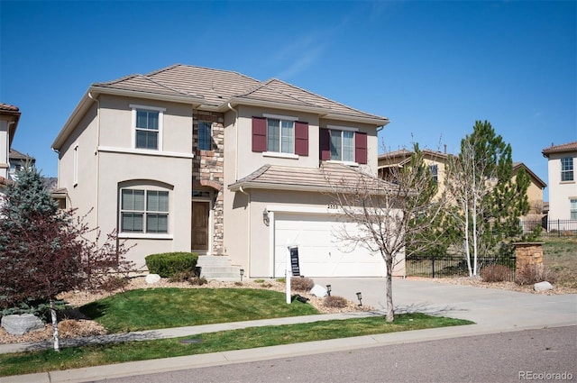 2559 S Kendrick St, Lakewood, CO 80228 - traditional-style house with fence, stone siding, a garage, stucco siding, and driveway
