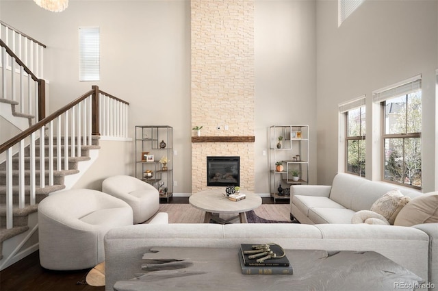 2559 S Kendrick St, Lakewood, CO 80228 - living area featuring plenty of natural light, stairs, a towering ceiling, and wood finished floors
