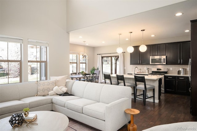 2559 S Kendrick St, Lakewood, CO 80228 - living area featuring recessed lighting, dark wood finished floors, and an inviting chandelier