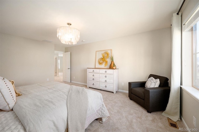2559 S Kendrick St, Lakewood, CO 80228 - bedroom featuring light colored carpet, baseboards, and a notable chandelier