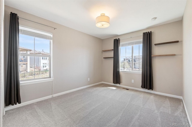 2559 S Kendrick St, Lakewood, CO 80228 - empty room featuring baseboards, carpet, and visible vents