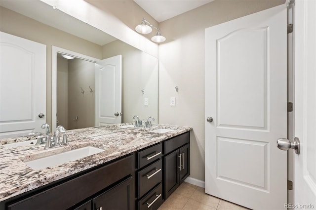 2559 S Kendrick St, Lakewood, CO 80228 - full bath with double vanity, tile patterned floors, and a sink