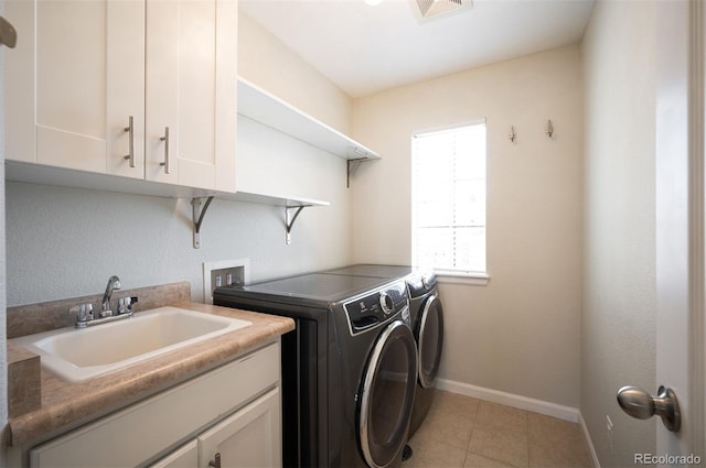 2559 S Kendrick St, Lakewood, CO 80228 - washroom with visible vents, cabinet space, a sink, baseboards, and separate washer and dryer