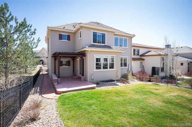 2559 S Kendrick St, Lakewood, CO 80228 - back of house featuring a pergola, a fenced backyard, stucco siding, a patio area, and a lawn