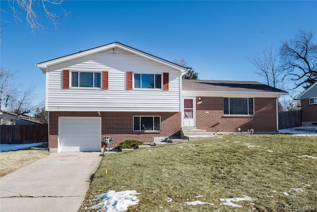 split level home with a front lawn and a garage