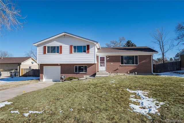 split level home featuring a front lawn and a garage