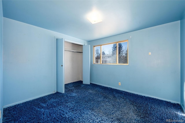 unfurnished bedroom featuring a closet and dark colored carpet