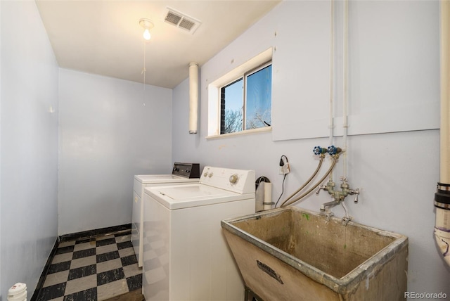 washroom featuring washing machine and dryer and sink